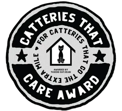 An awards badge for catteries that care featuring a silhouette of a cat in a house