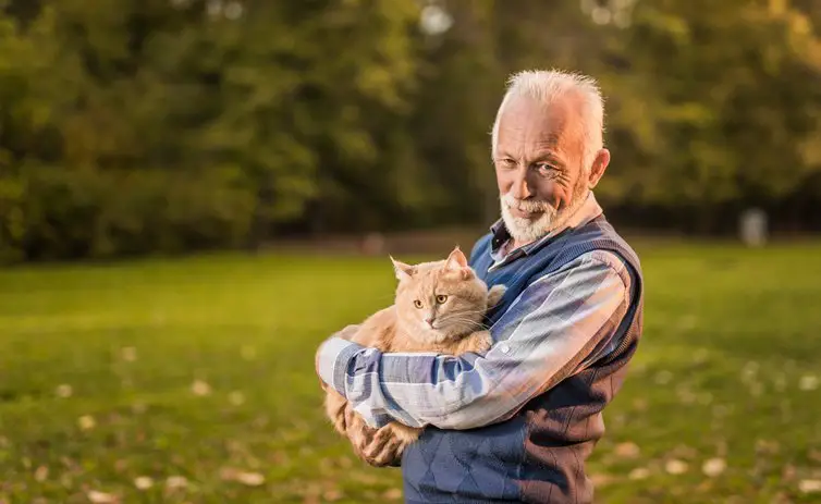senior man holding a cat